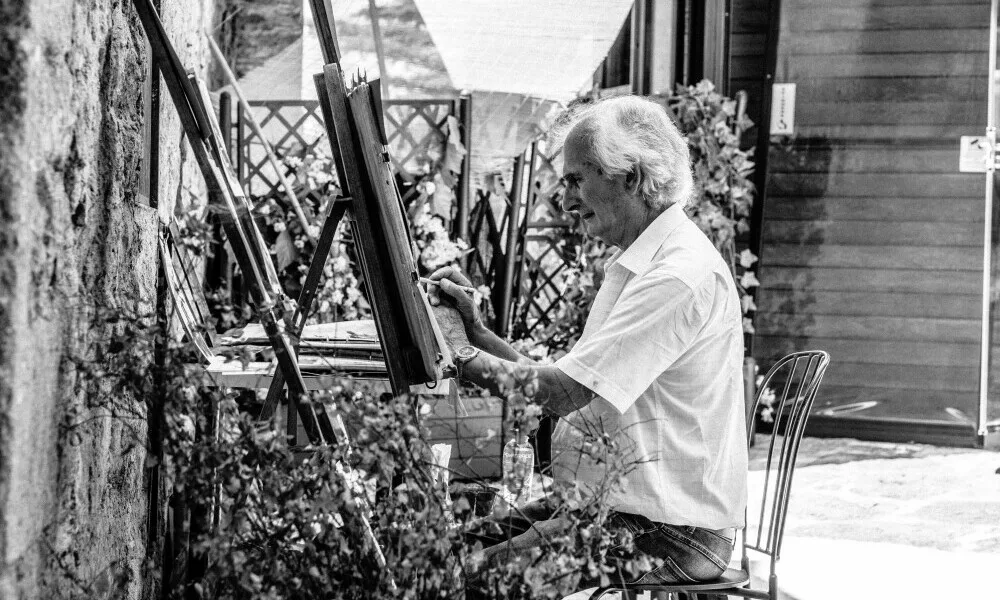 an artist sat at an easel. How long is he going to take to complete his painting?