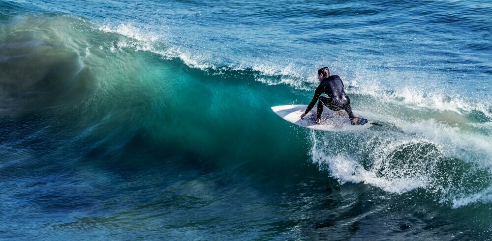 a surfer keeping ahead of the curve